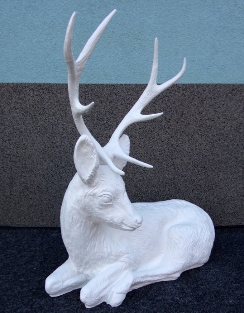 Jeleń leżący biały